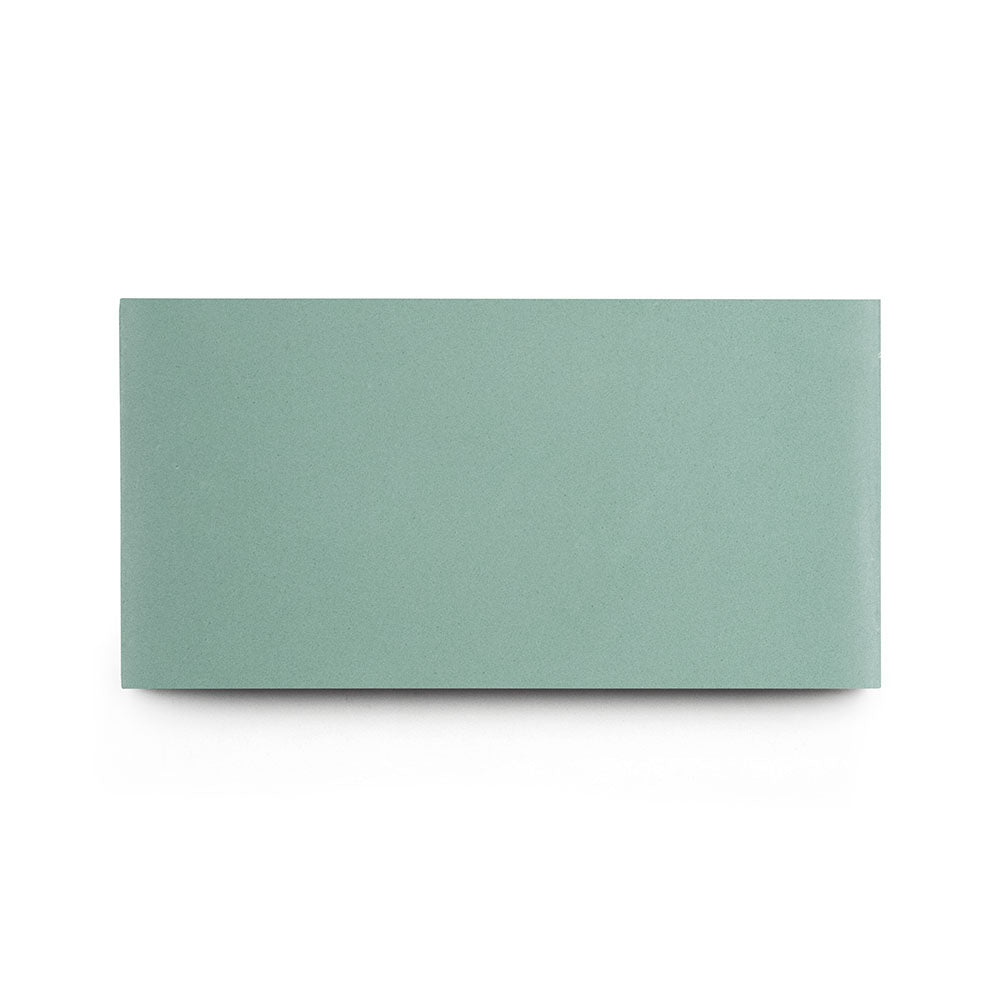 The Salvia 4x8 cement tile is a rectangular, solid, flat tile in green-gray, great for kitchen backsplashes. Photographed on a white background.