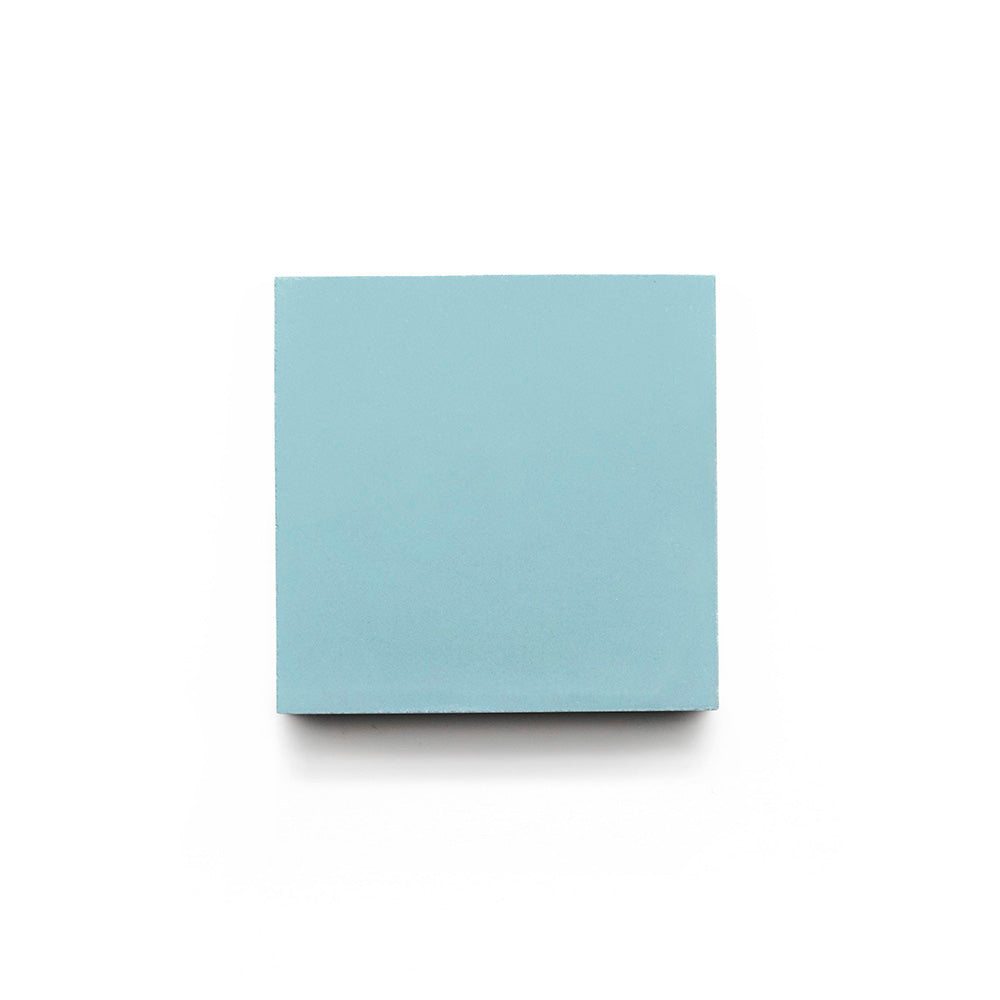 A single Sky Blue 4x4 Sample from vendor-unknown is centered on a white background, viewed from above—reminiscent of a handmade tile.
