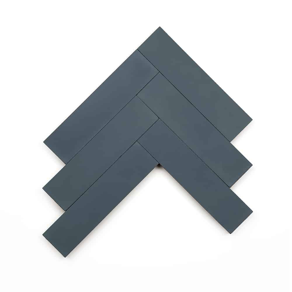 Five Slate 2x8 tiles from vendor-unknown, in dark gray cement, are arranged in a herringbone pattern on a white background.