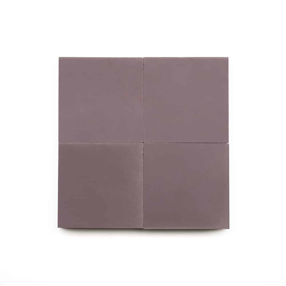 Four Tyrian 4x4 matte mauve cement tiles are arranged in a grid on a white background, forming a larger square — an elegant modern kitchen backsplash option.