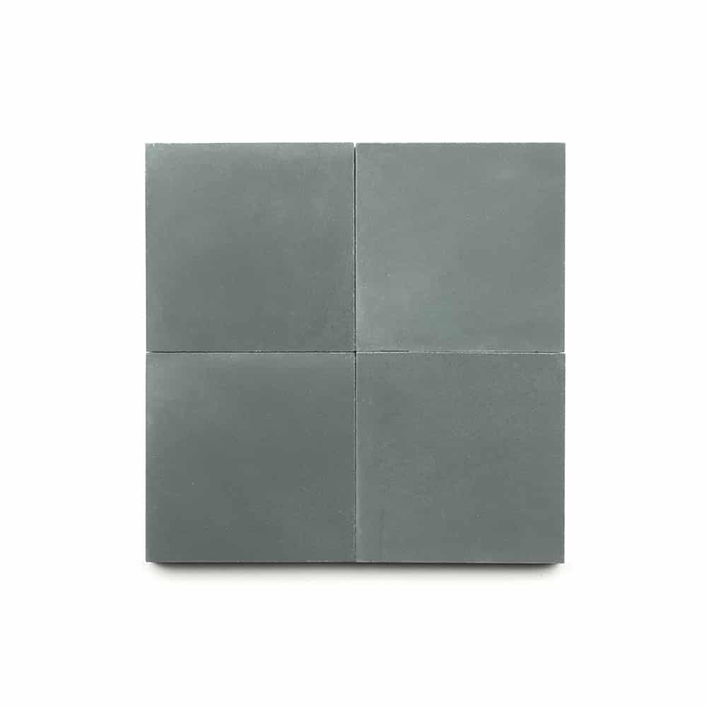 Four Zeppelin 4x4 tiles in matte gray are displayed in a 2x2 grid on a white background, adding a modern touch ideal for kitchen backsplashes.