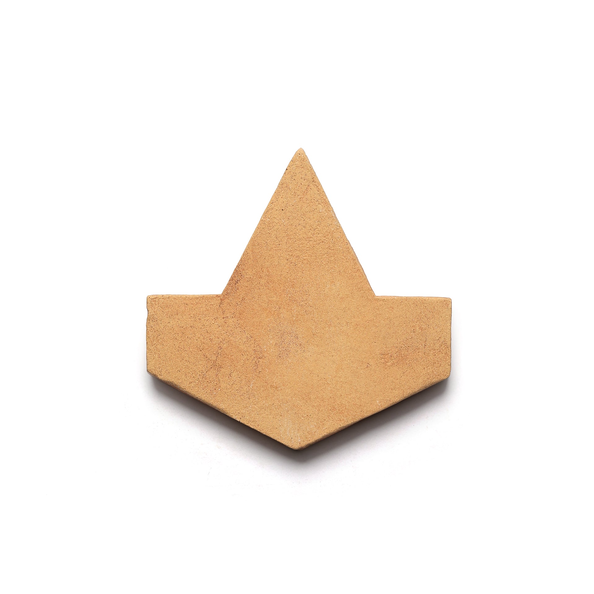 The Alcazar + Adobe tile by Zia Tile features a tan, geometric Cotto clay design with a triangular peak, evoking artisanal San Miguel de Allende charm against a white backdrop.