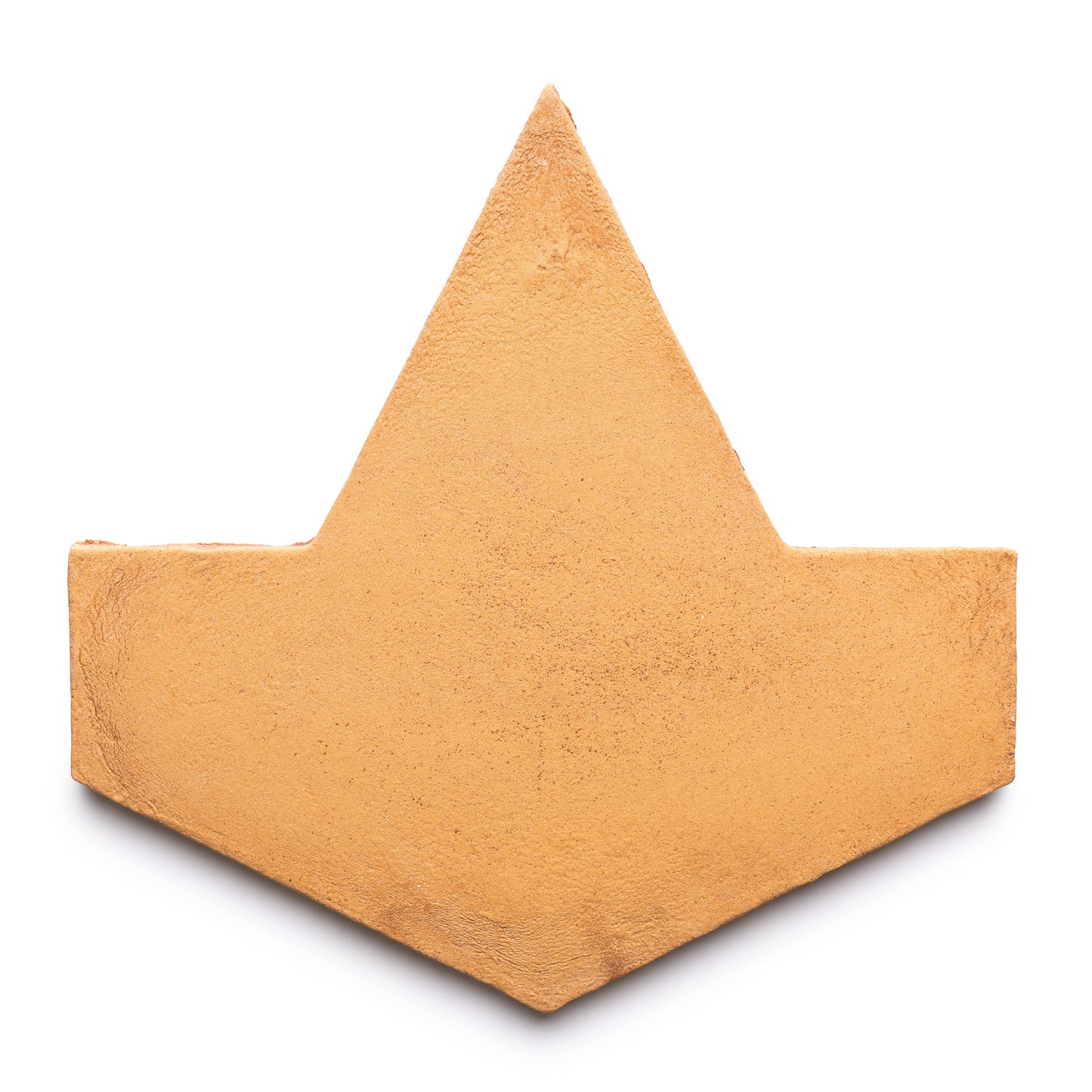 The Big Alcazar + Adobe by Zia Tile is a flat, textured, golden-brown tile shaped like a stylized paper boat or geometric crown, shown isolated on a white background.