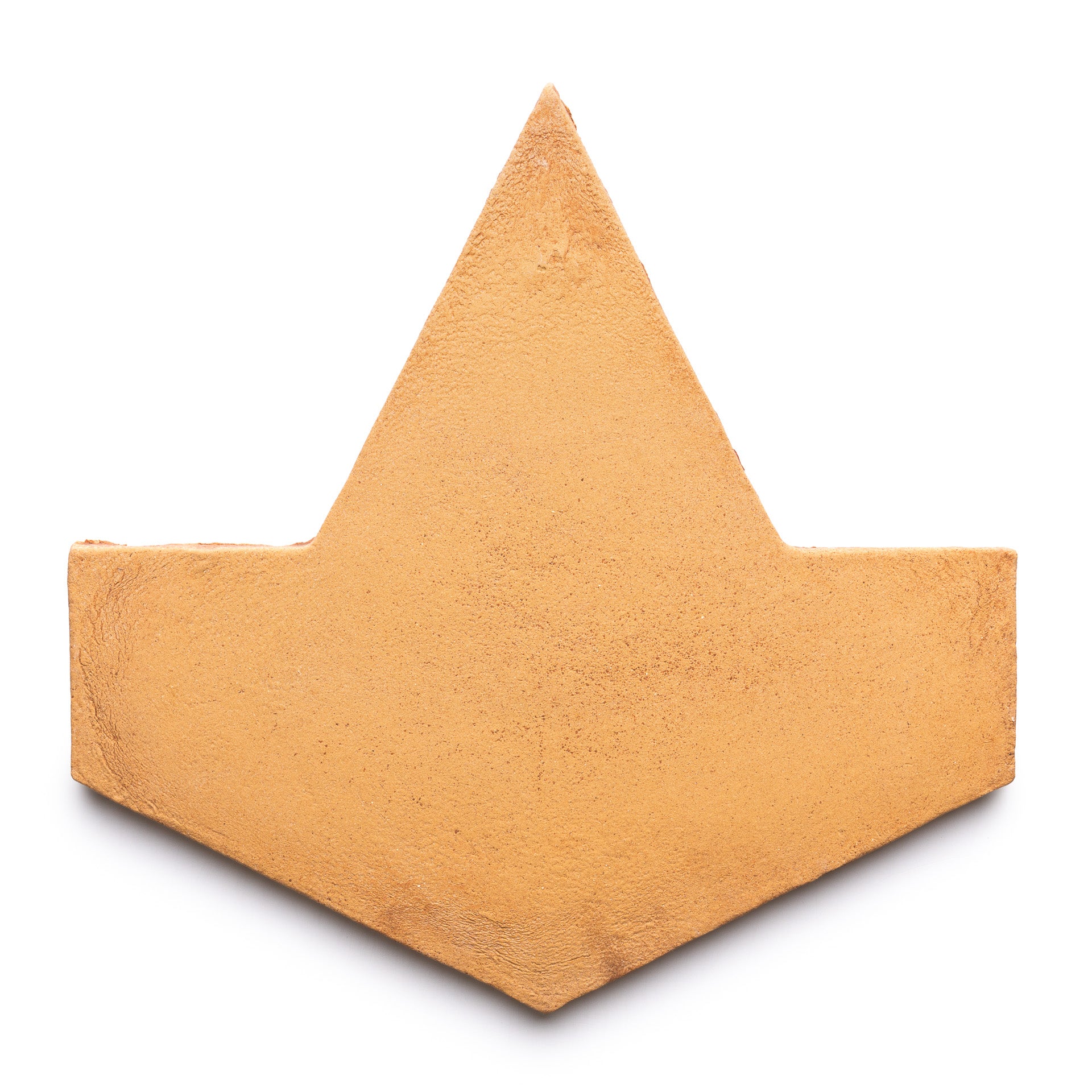 The Big Alcazar + Adobe by Zia Tile is a flat, textured, golden-brown tile shaped like a stylized paper boat or geometric crown, shown isolated on a white background.