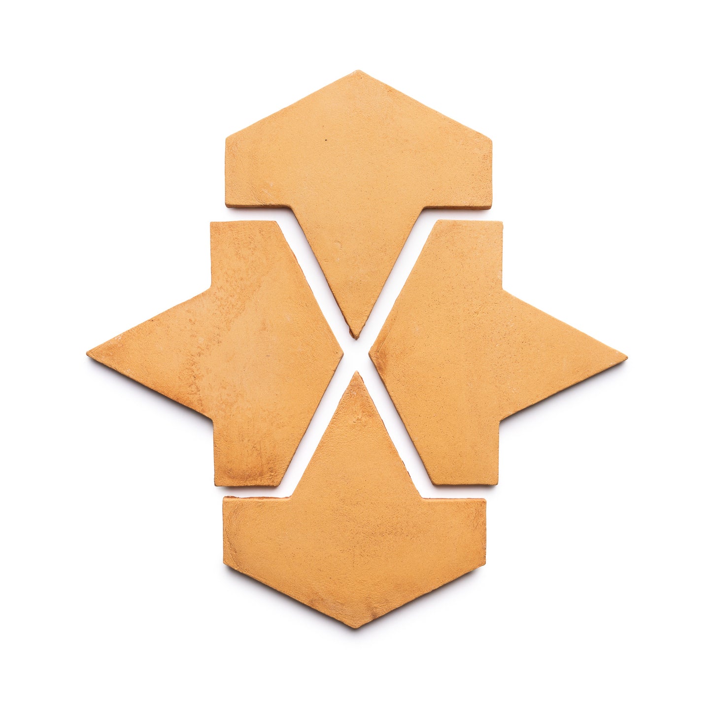 Four Big Alcazar + Adobe geometric terracotta tiles from Zia Tile with pointed ends are arranged on a white background to create a symmetrical, star-like pattern featuring central negative space.