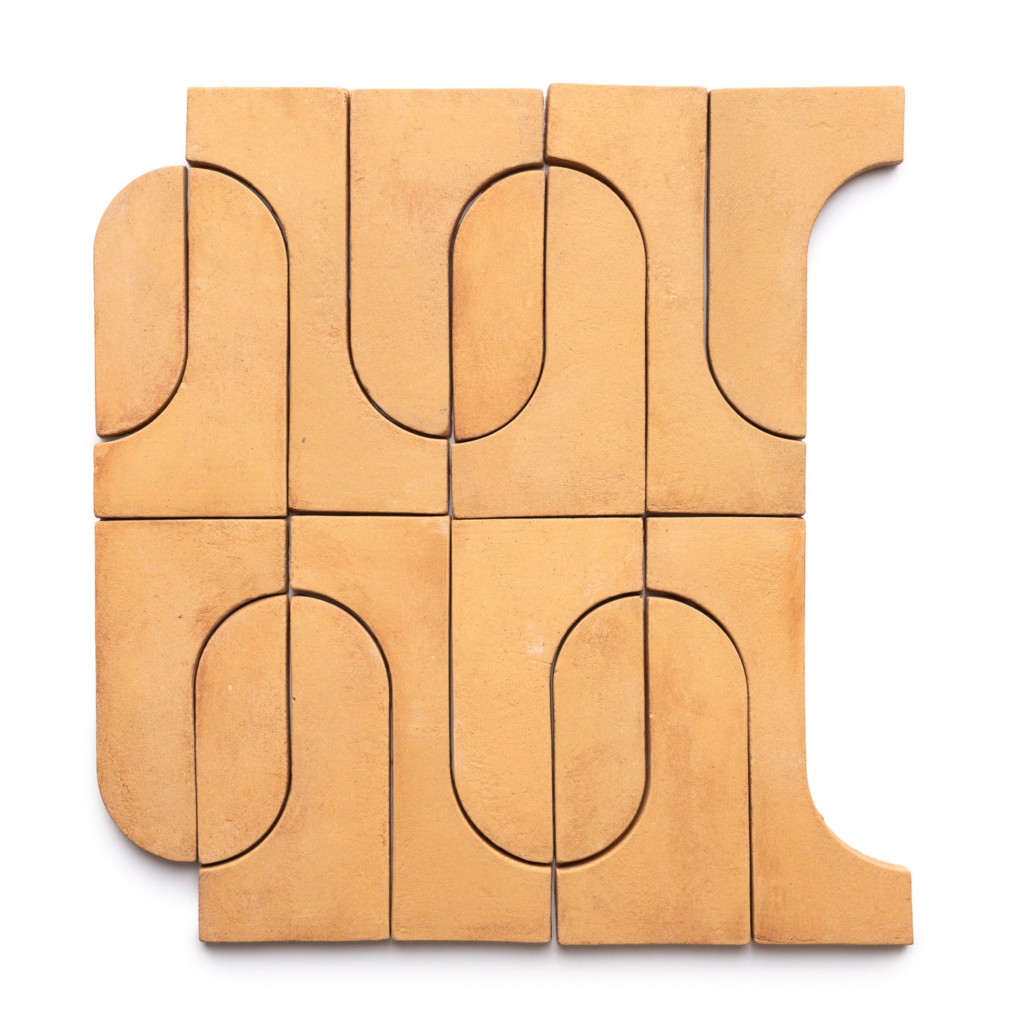 Durango + Adobe by Zia Tile features tan geometric clay tiles with both curved and straight edges, arranged in a square abstract pattern on a white background.