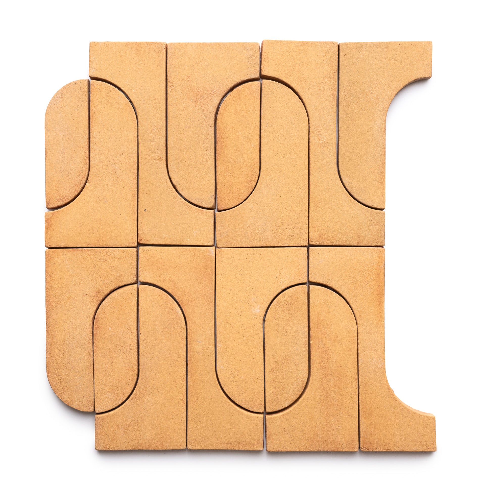 Durango + Adobe by Zia Tile features tan geometric clay tiles with both curved and straight edges, arranged in a square abstract pattern on a white background.