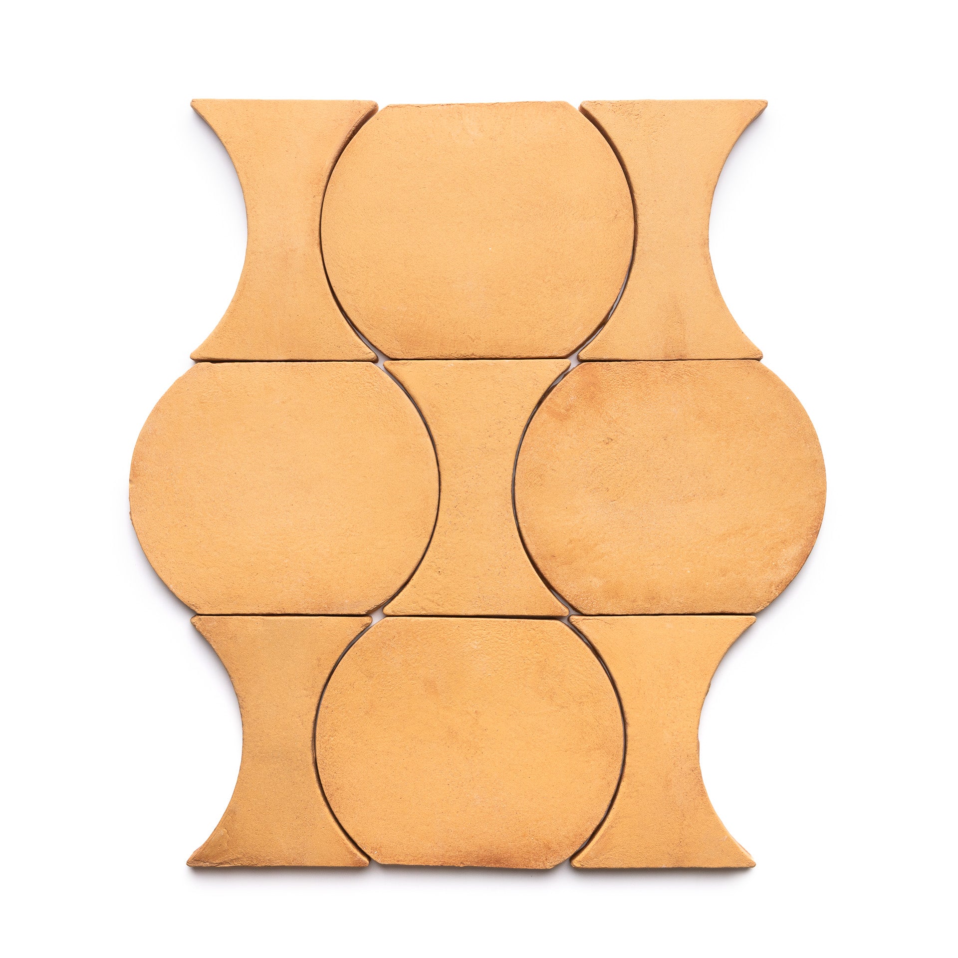 Six tan Oaxaca + Adobe ceramic tiles by Zia Tile are arranged in a geometric pattern with circular and concave sides, forming an interlocking, symmetrical design on a white background.