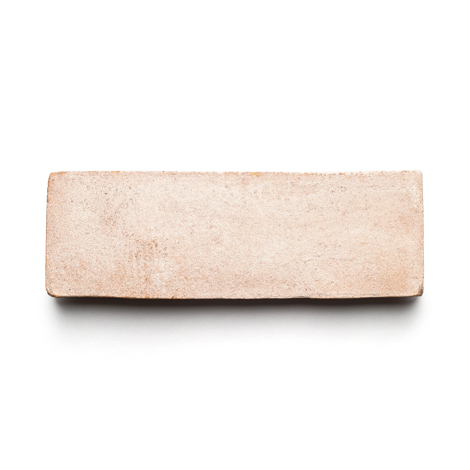 A single 2x6 Rectangle + Blanco brick from Zia Tile, light brown with a smooth, handmade Cotto look, shown on a white background.