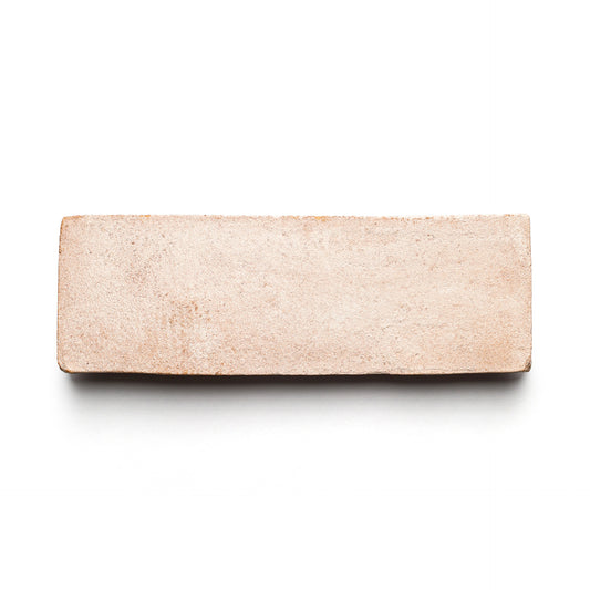 A single 2x6 Rectangle + Blanco brick from Zia Tile, light brown with a smooth, handmade Cotto look, shown on a white background.