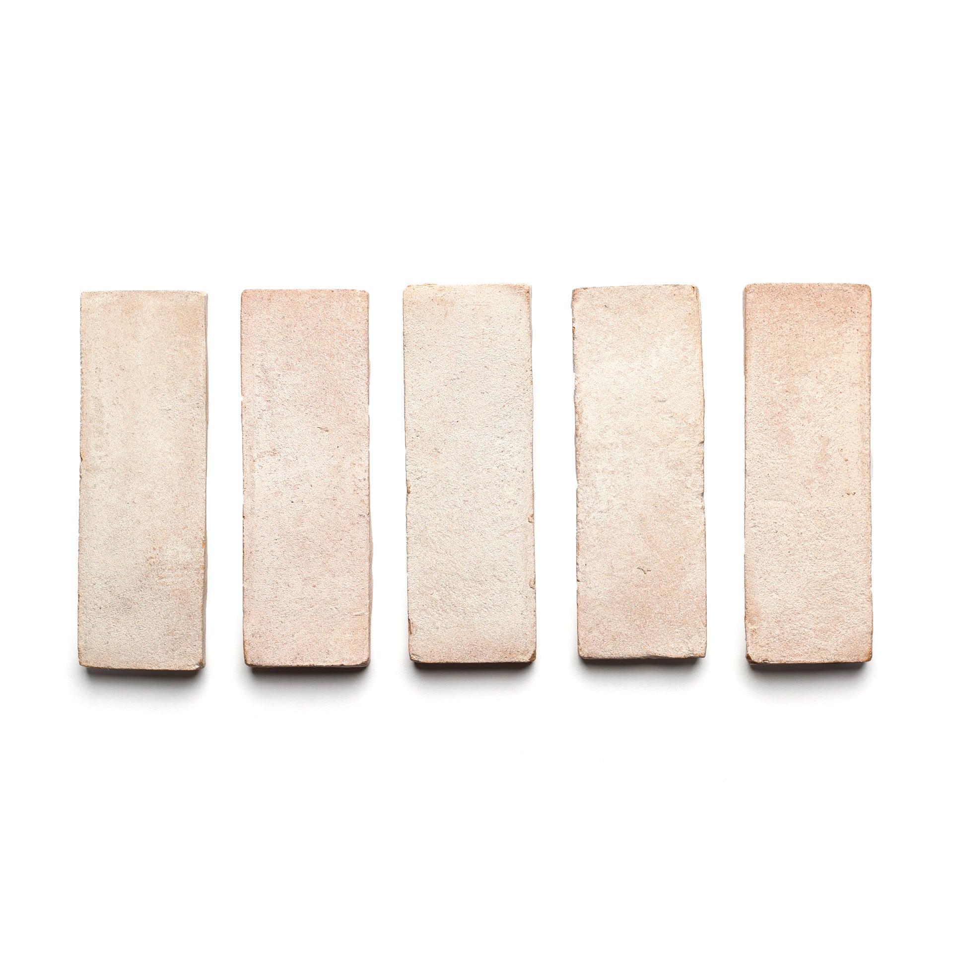 Five 2x6 Rectangle + Blanco bricks by Zia Tile are displayed in a horizontal row on a white background, evenly spaced and viewed from above, showcasing the elegance of handcrafted ceramics.