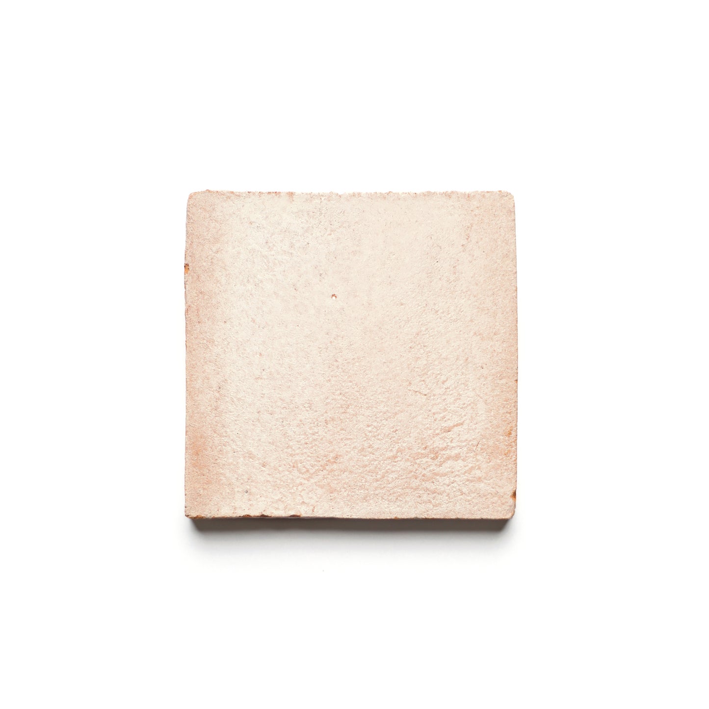 The Zia Tile 4x4 Square + Blanco is a light pink, square ceramic tile with a slightly rough texture, shown on a white background.
