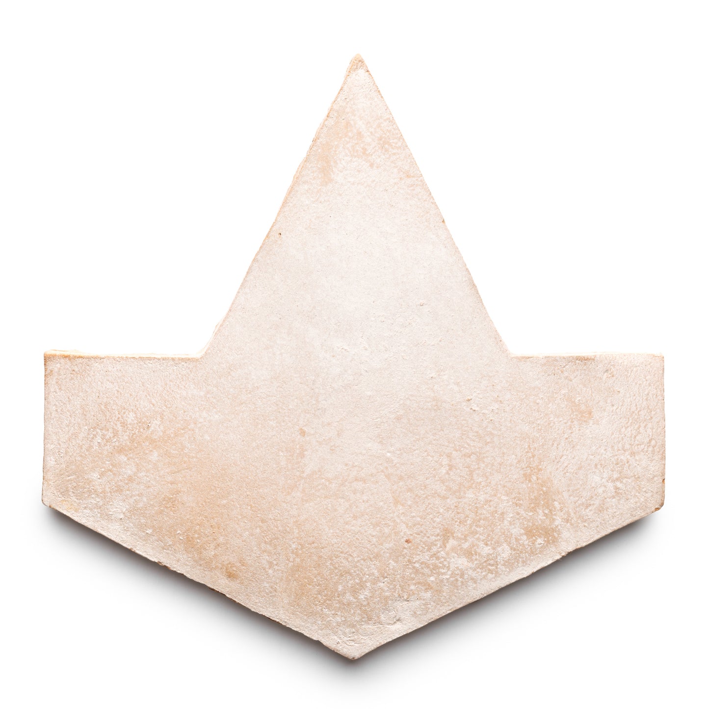 A single Big Alcazar + Blanco tile by Zia Tile, featuring a light beige hue and geometric design with a pointed top and two angled lower edges, shown isolated on a white background.