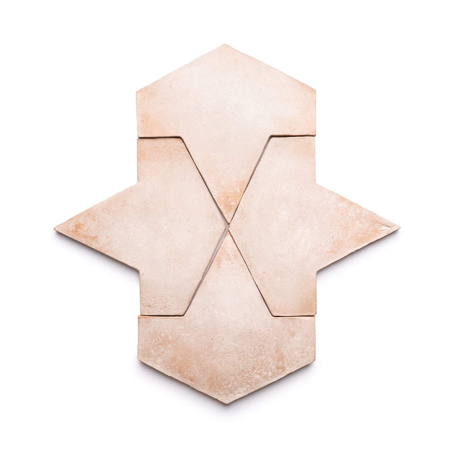 Four Big Alcazar + Blanco tiles by Zia Tile are arranged on a white background, creating a geometric, symmetrical pattern that resembles an abstract arrow or star.