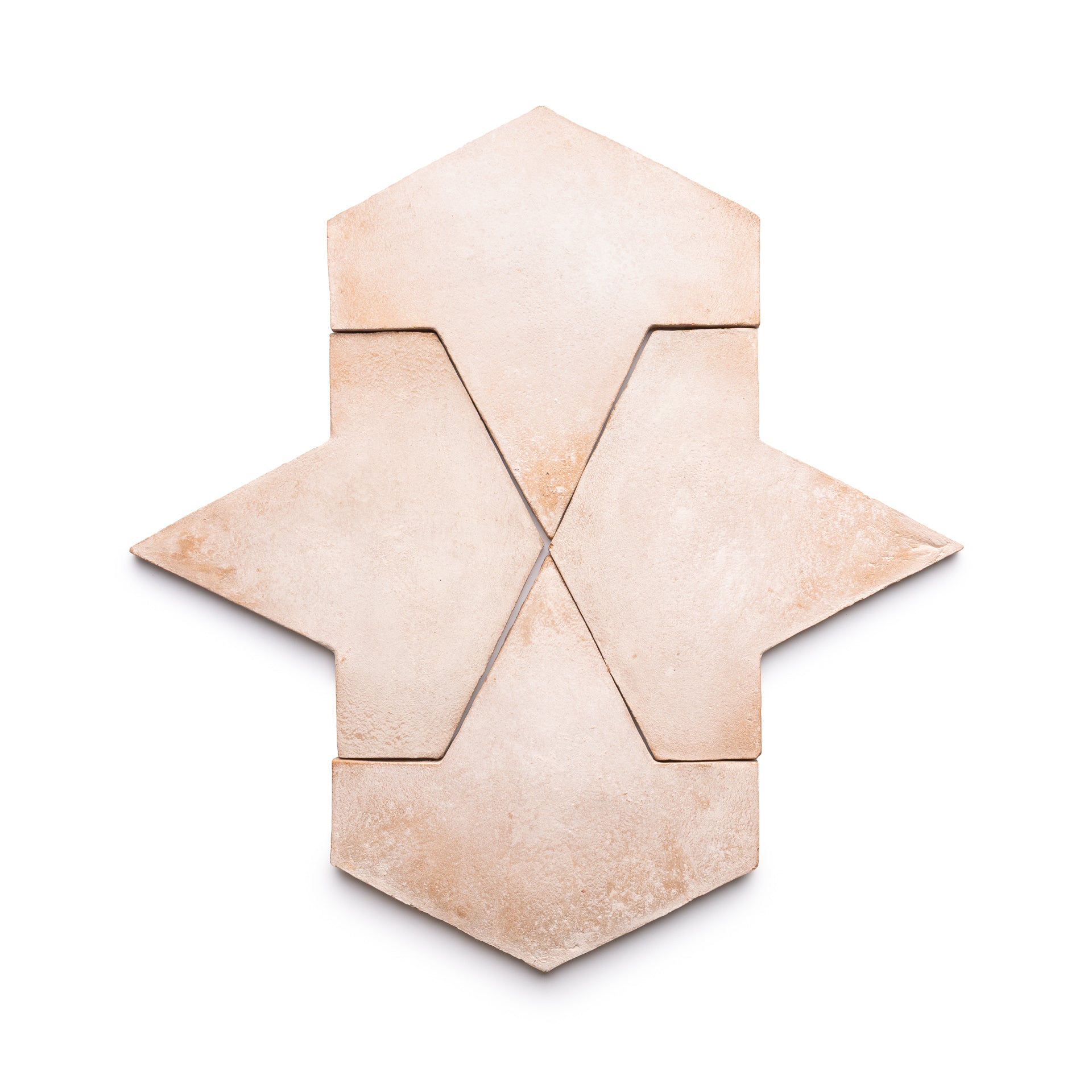 Four Big Alcazar + Blanco tiles by Zia Tile are arranged on a white background, creating a geometric, symmetrical pattern that resembles an abstract arrow or star.