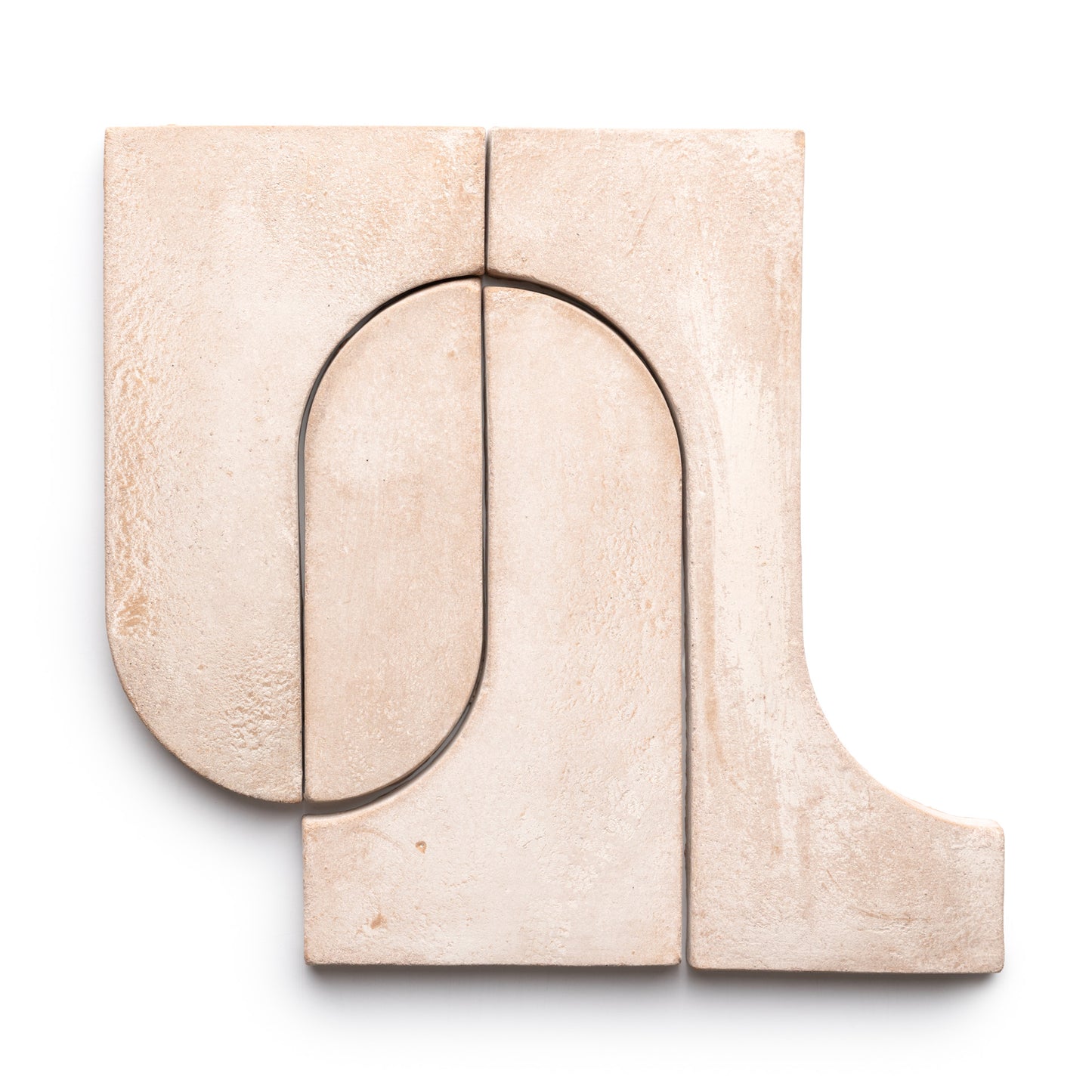 Four beige Durango + Blanco ceramic tiles from Zia Tile, featuring textured surfaces and a mix of curved and straight edges, are arranged in a geometric abstract pattern on a white background.