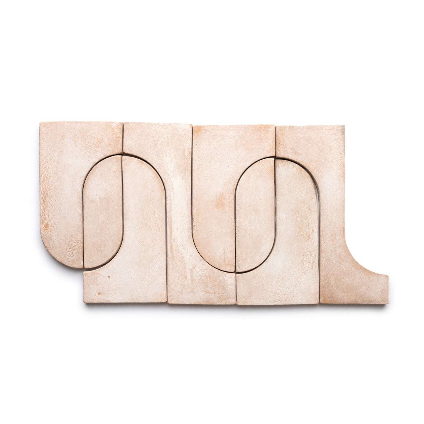 Five Durango + Blanco tiles by Zia Tile, in beige with curved indentations, are arranged side by side to create a continuous wavy, minimalist, and abstract pattern.