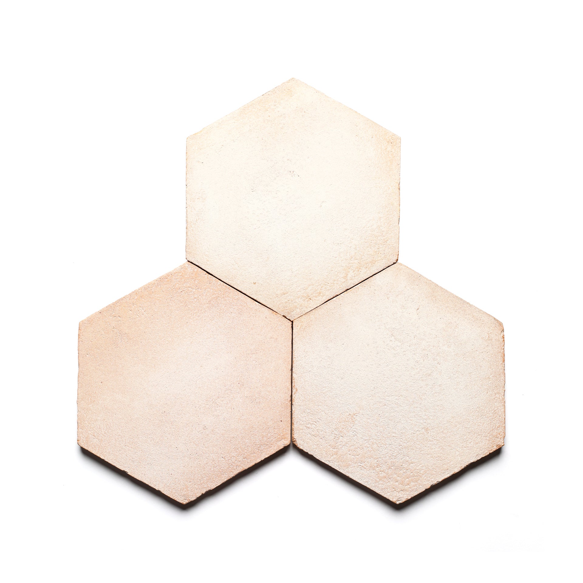 Three 8x9 Hex + Blanco tiles by Zia Tile, inspired by handmade Cotto ceramic arts, are arranged in a honeycomb pattern on a white background.