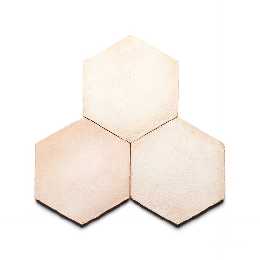 Three 8x9 Hex + Blanco tiles by Zia Tile, inspired by handmade Cotto ceramic arts, are arranged in a honeycomb pattern on a white background.
