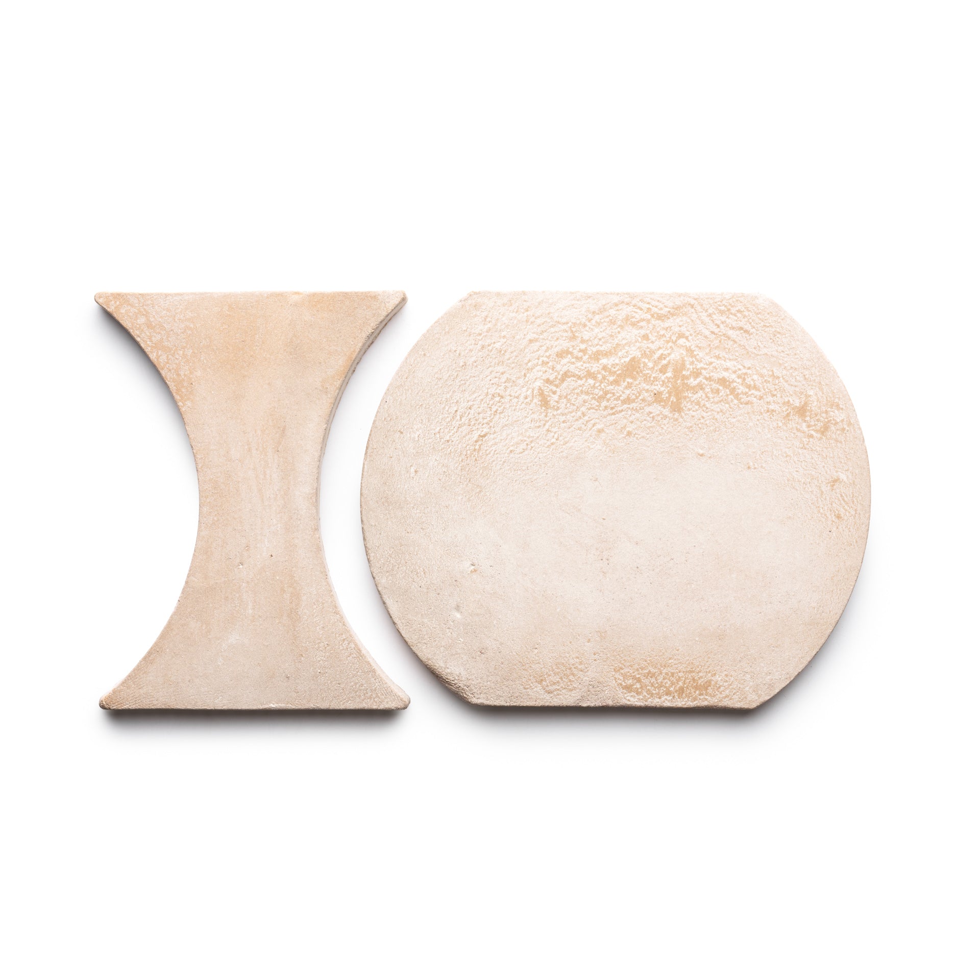 Two Oaxaca + Blanco tiles from Zia Tile are displayed on a white background. One is hourglass-shaped, the other a rounded rectangle with chamfered corners. Both feature a textured, matte finish.