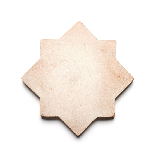 The Stars & Cross + Blanco tile by Zia Tile is a beige, eight-pointed handmade ceramic with a rough texture, inspired by San Miguel de Allende, shown on a white background.