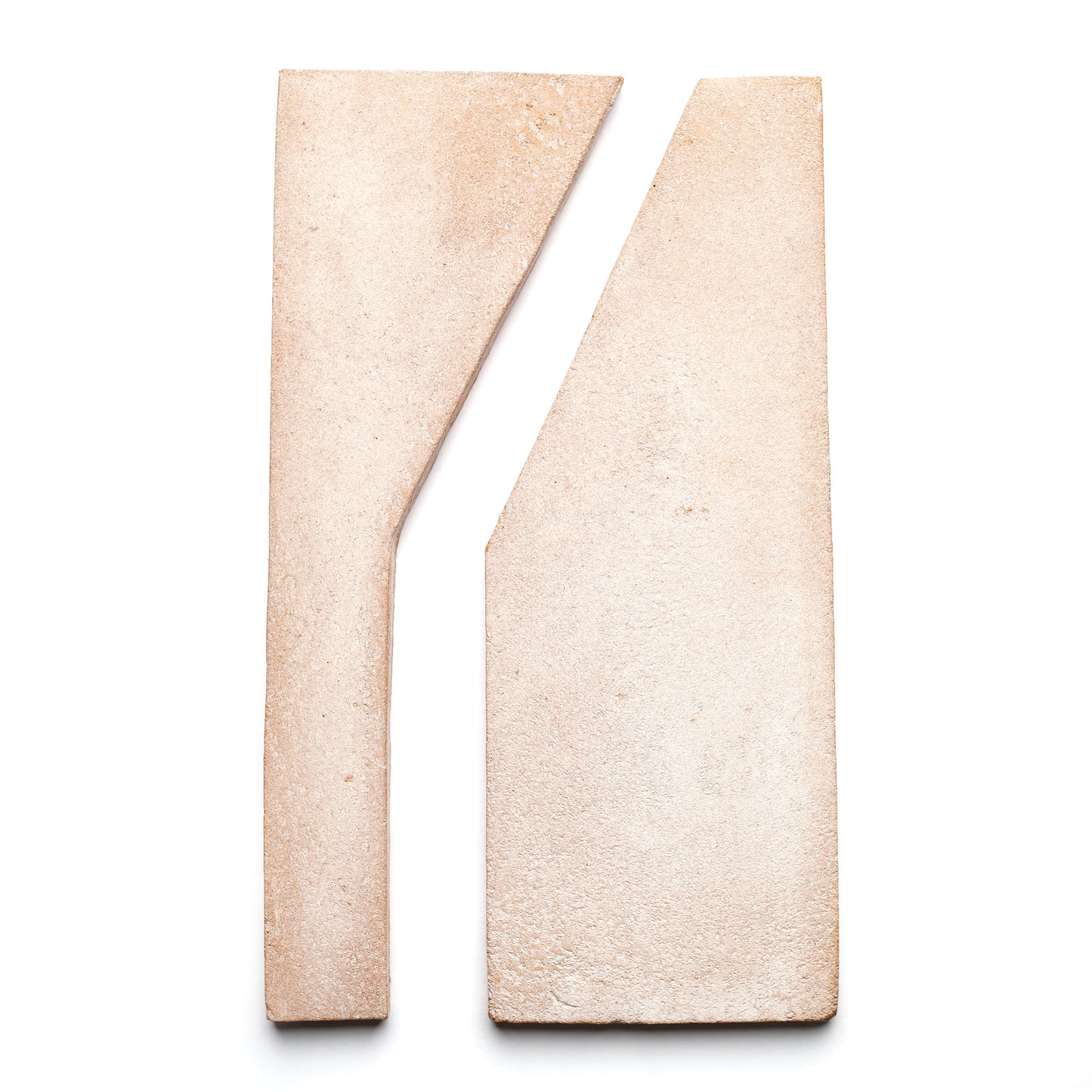 Two beige Zocalo and white Blanco handmade ceramic tiles from Zia Tile, placed side by side with a diagonal cut, create an abstract geometric composition on a white background.