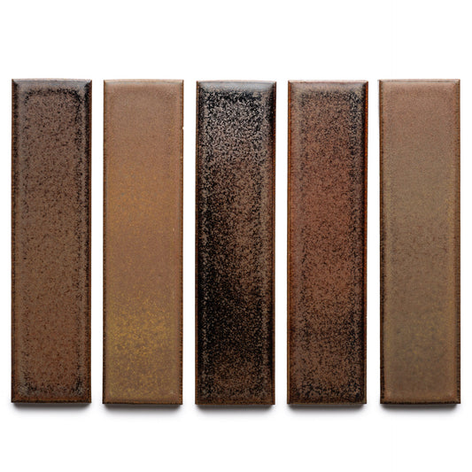 Five Buckeye + Flat ceramic tiles by Zia Tile are arranged vertically, each displaying a unique earthy brown gradient with black speckles on a white background.
