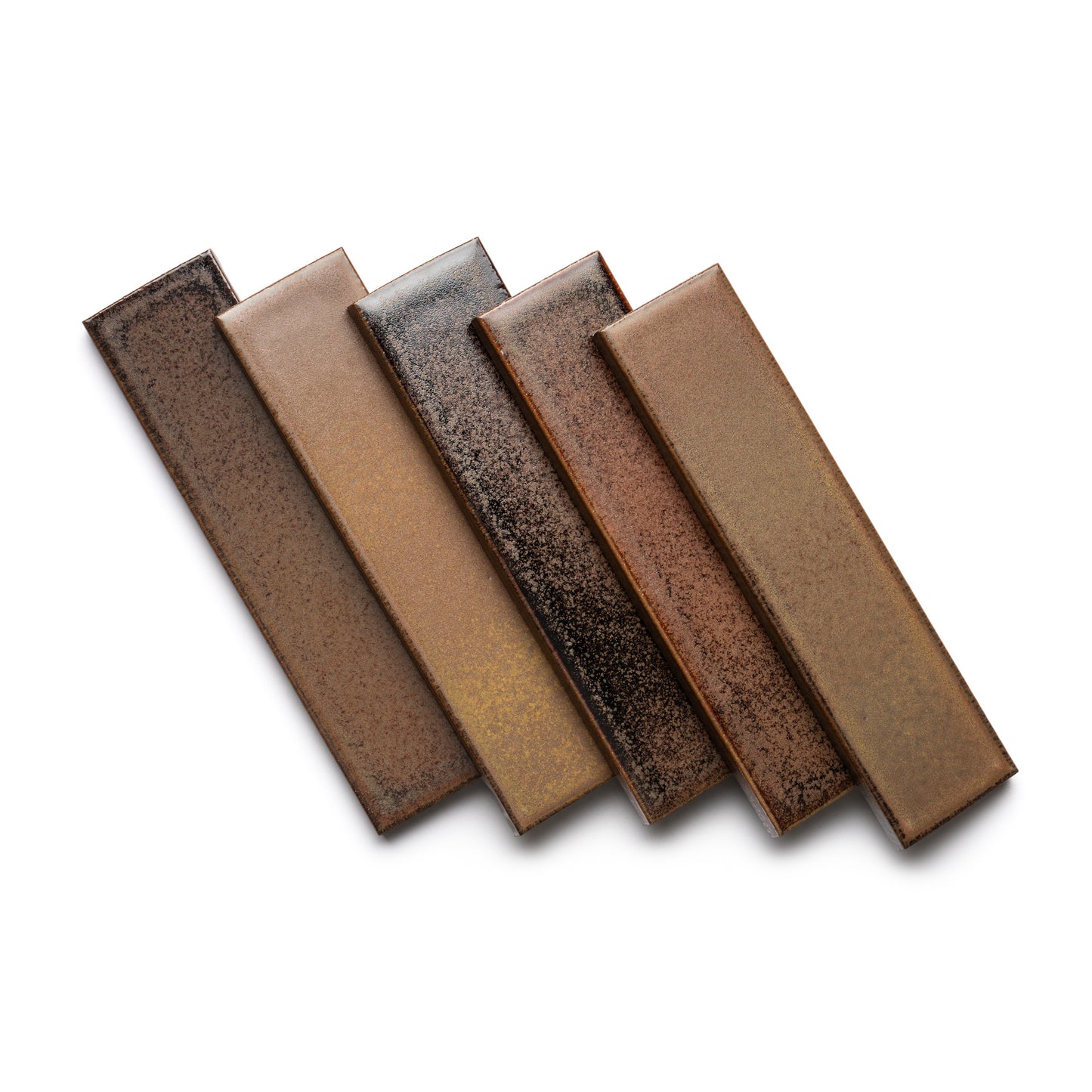 Five rectangular Buckeye + Flat ceramic tiles by Zia Tile, in shades of brown and tan with a speckled, textured finish, are arranged in a staggered pattern on a white background.