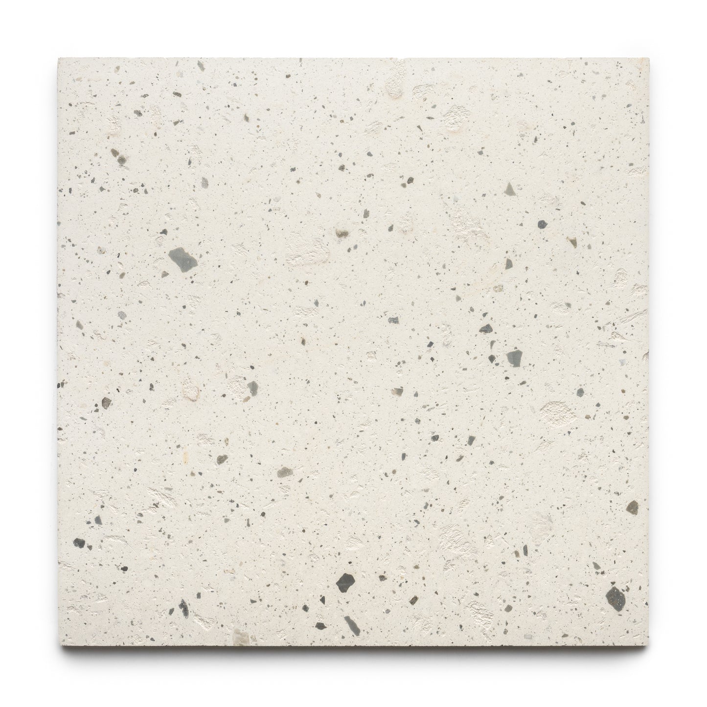 The Caldera 24x24 tile by Zia Tile is a square, off-white terrazzo tile with small, irregular gray and beige stone chips throughout, displayed on a plain white background.
