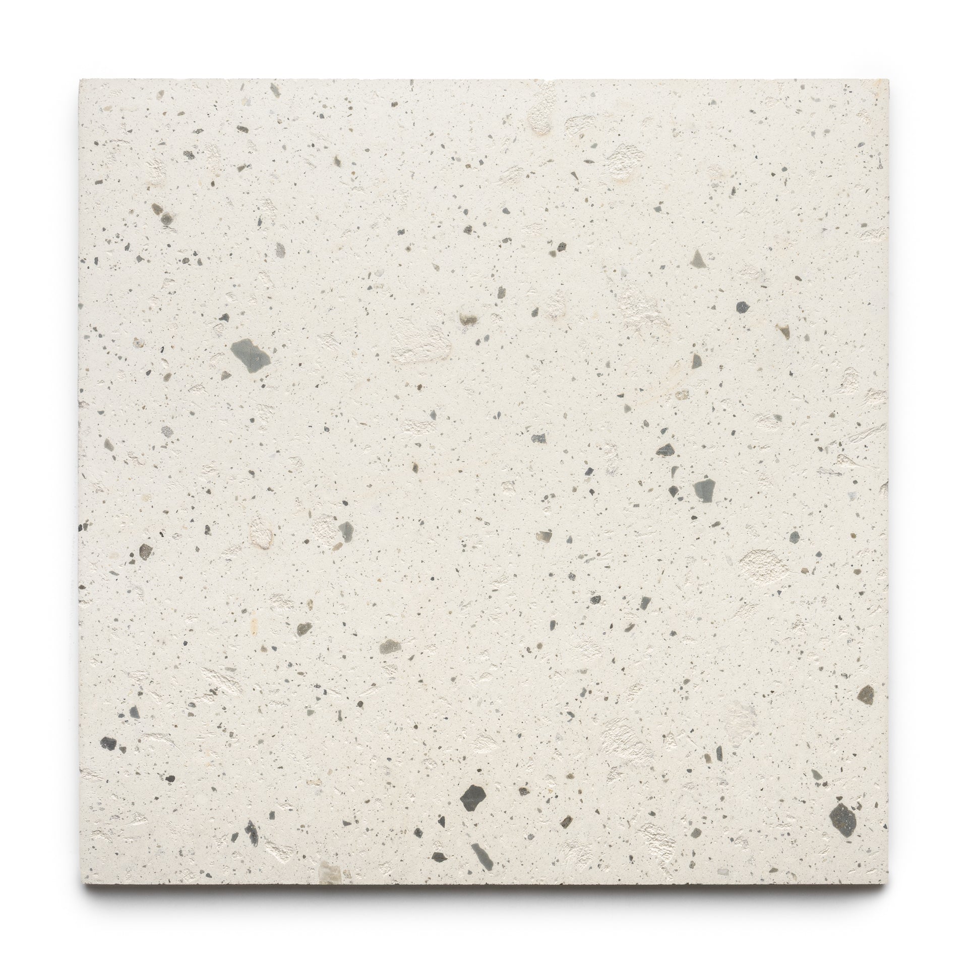 The Caldera 24x24 tile by Zia Tile is a square, off-white terrazzo tile with small, irregular gray and beige stone chips throughout, displayed on a plain white background.