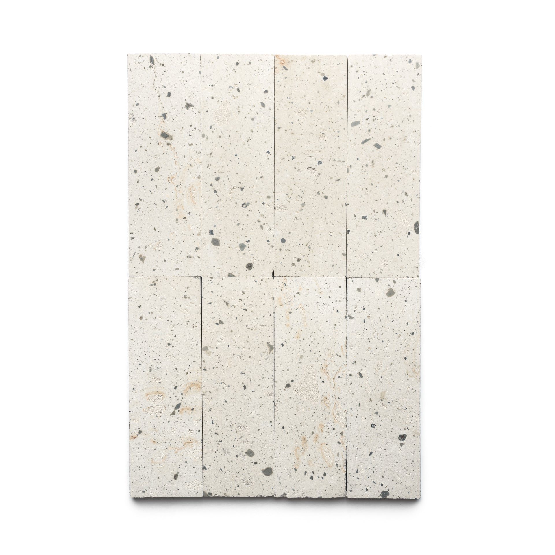 Rectangular arrangement of eight Zia Tile Caldera 4x12 tiles, featuring light-colored speckles with subtle gray and beige hues, set against a plain white background.