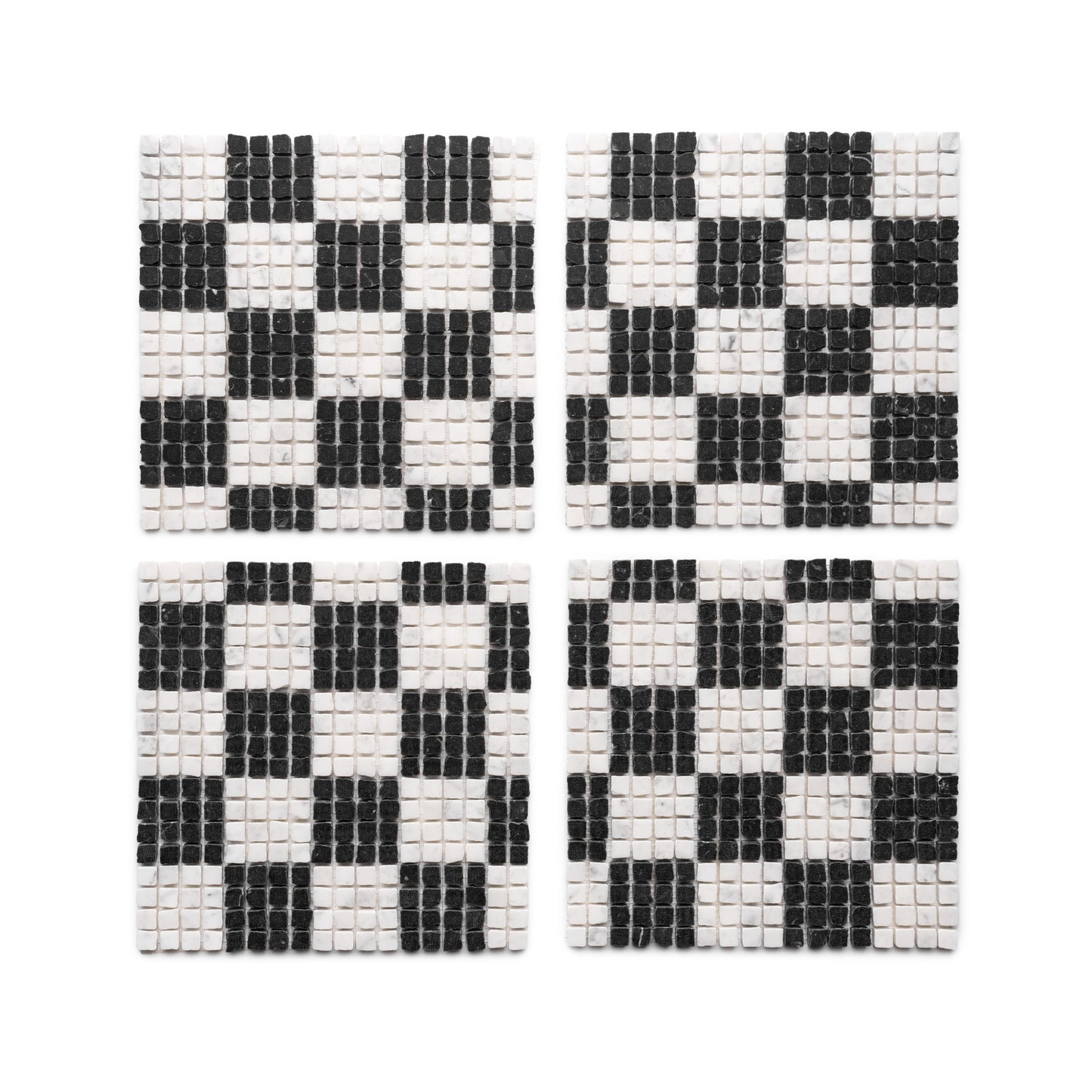 Four square coasters from Zia Tile’s Check in Carrara + Nero Marquina collection are arranged in a grid, each displaying a black and white checkerboard pattern made from small tiles.