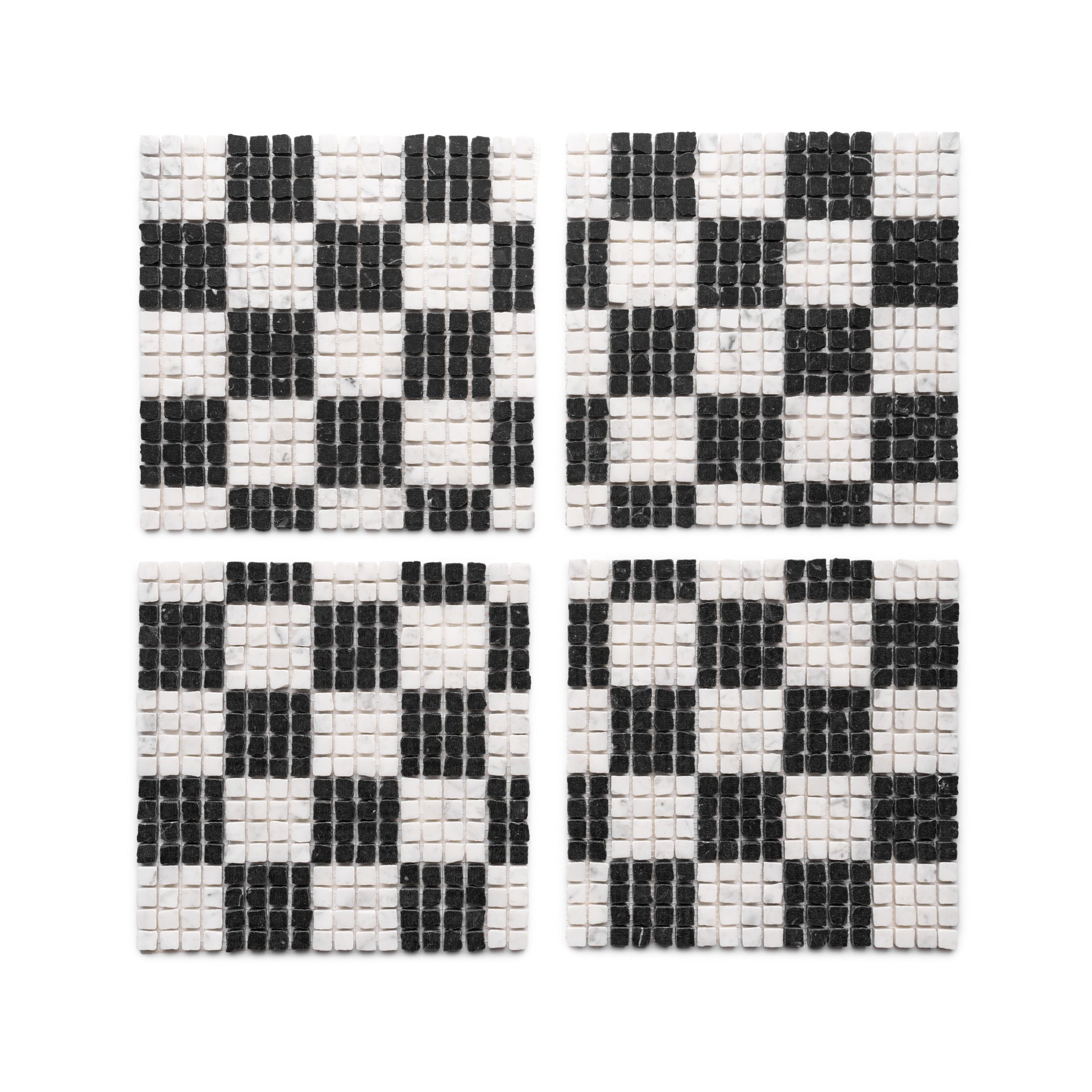 Four square coasters from Zia Tile’s Check in Carrara + Nero Marquina collection are arranged in a grid, each displaying a black and white checkerboard pattern made from small tiles.