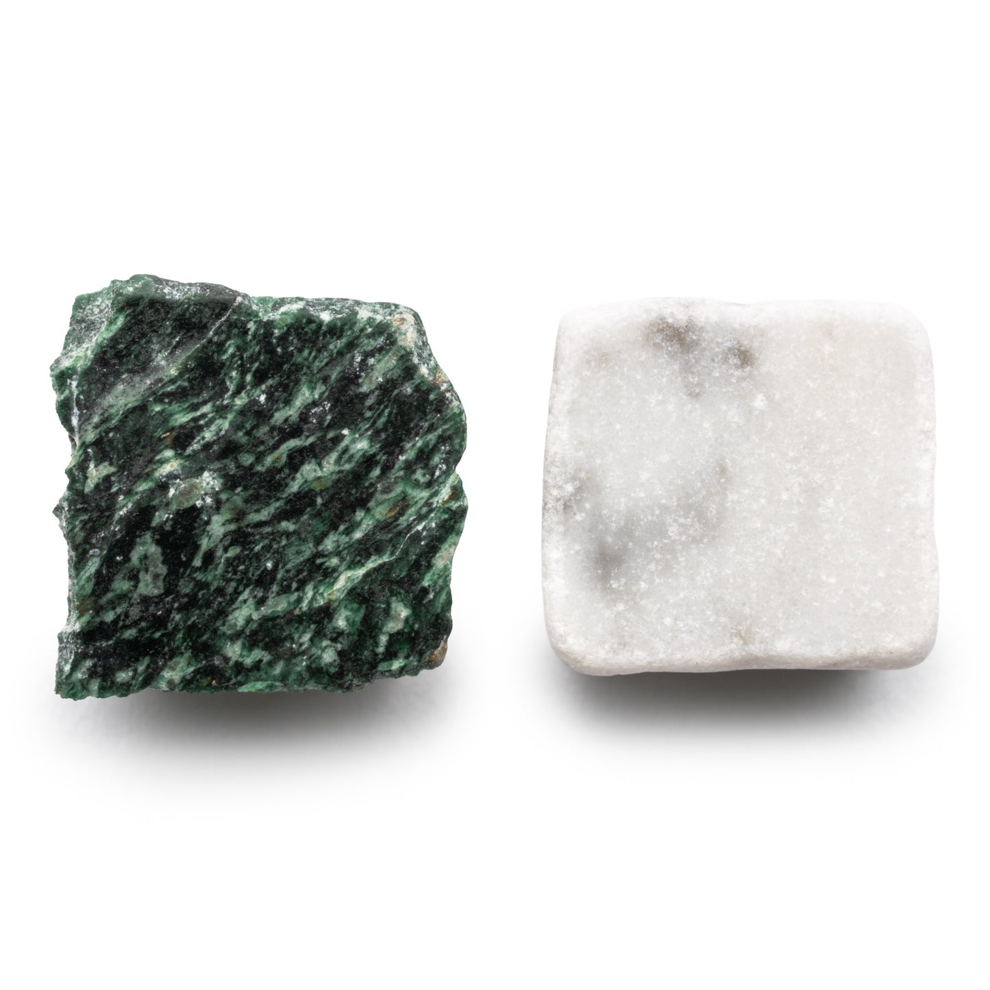 Check in Carrara + Verde Alpi by Zia Tile shown: a rough, green and black jagged stone (left), and a smooth, white stone with subtle gray patches and a square shape (right), both on a white background.