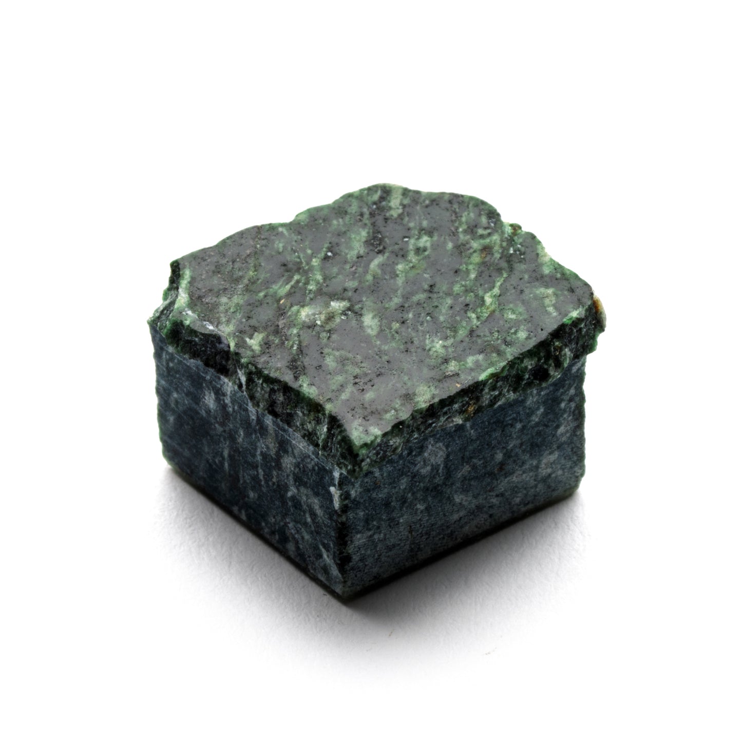 Check in Carrara + Verde Alpi by Zia Tile: a rough, square green mineral rock with a dark mottled surface and lighter green streaks, shown isolated on a white background.