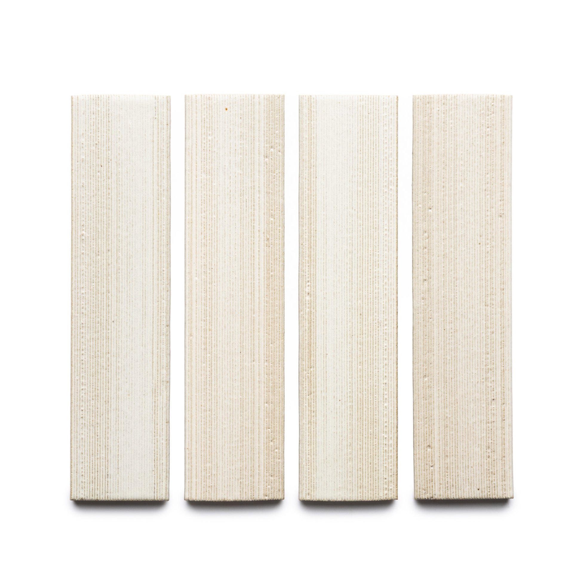 Four rectangular Feather + Etched cream-colored tiles by Zia Tile, featuring a textured grid-like surface, are displayed vertically in a row on a white background.