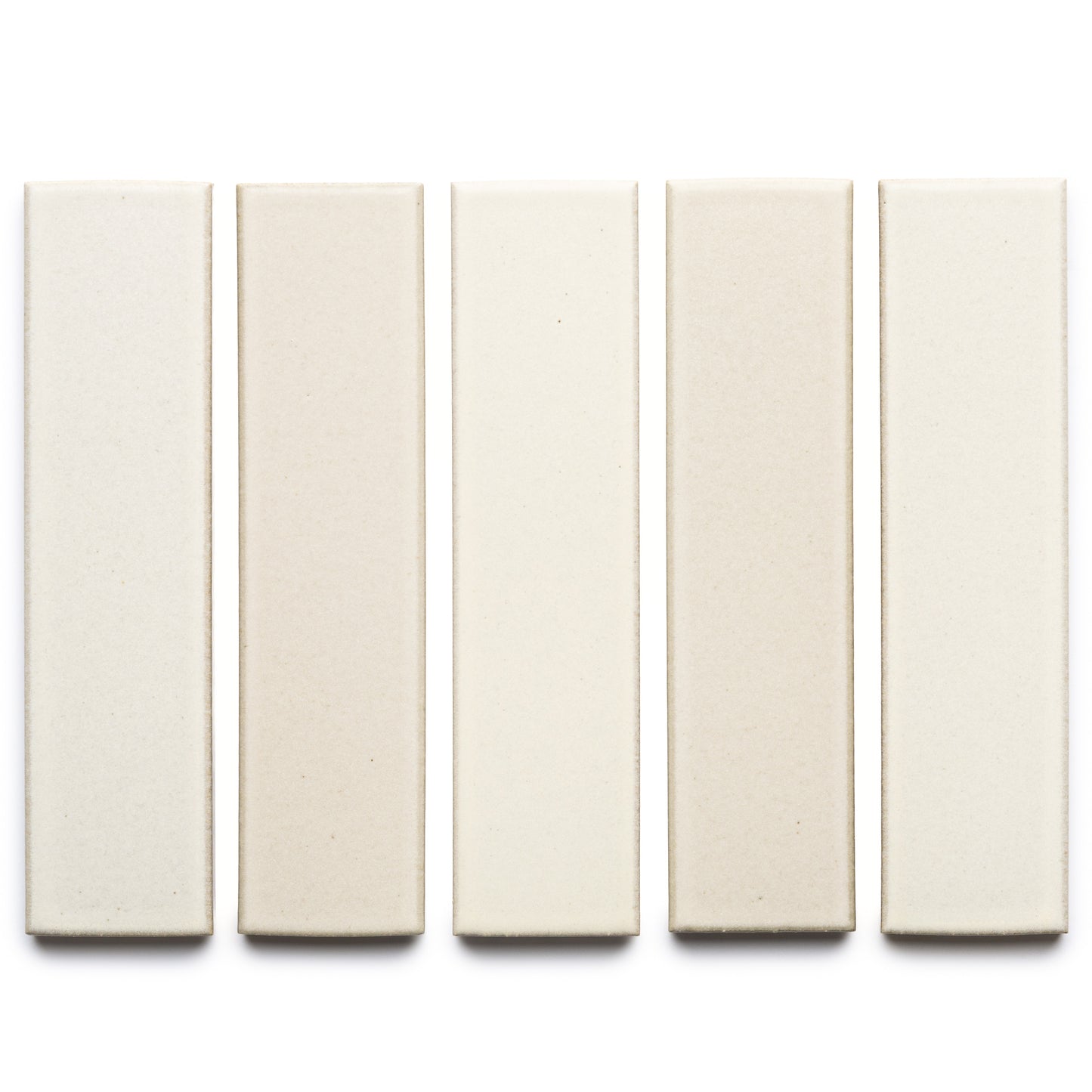 Five rectangular Feather + Flat ceramic tiles by Zia Tile in varied off-white and beige shades are arranged vertically in a row on a white background.