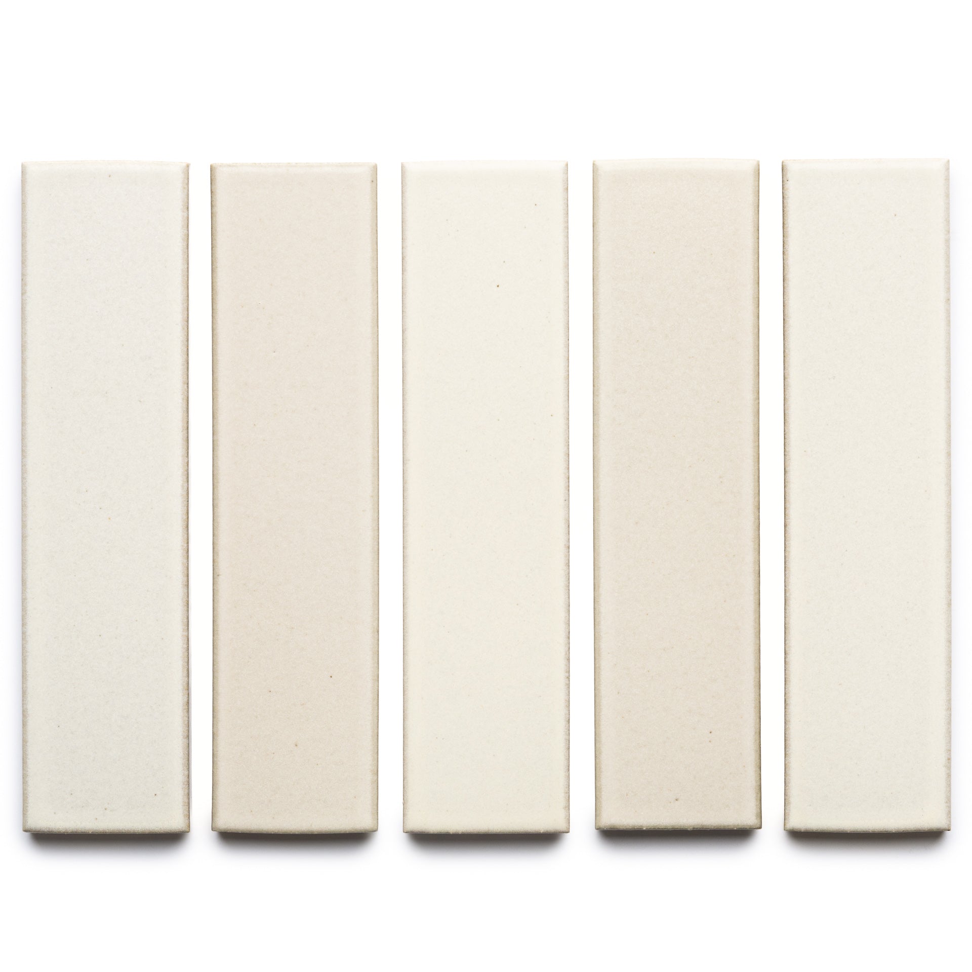 Five rectangular Feather + Flat ceramic tiles by Zia Tile in varied off-white and beige shades are arranged vertically in a row on a white background.