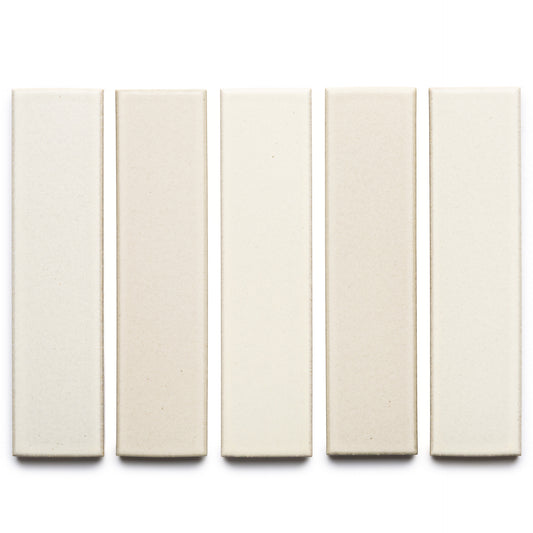 Five rectangular Feather + Flat ceramic tiles by Zia Tile in varied off-white and beige shades are arranged vertically in a row on a white background.