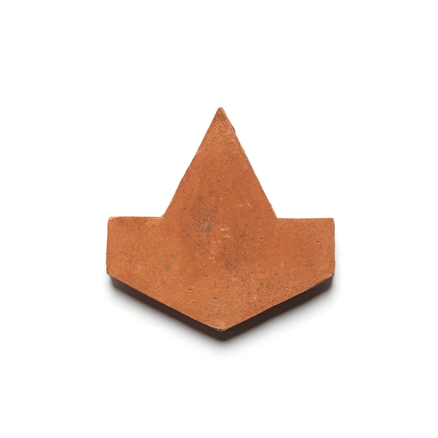 The Alcazar + Fired Earth tile by Zia Tile is a reddish-brown, diamond-shaped terra cotta tile with flat horizontal edges, set against a white background, showcasing ceramic artistry.