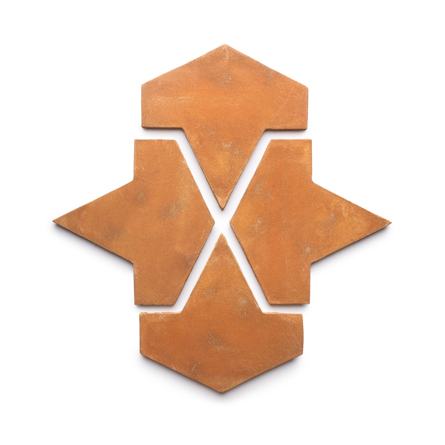 Four Big Alcazar + Fired Earth terracotta tiles by Zia Tile arranged on a white background, each arrowhead-shaped, form a geometric star-like pattern with an open center.