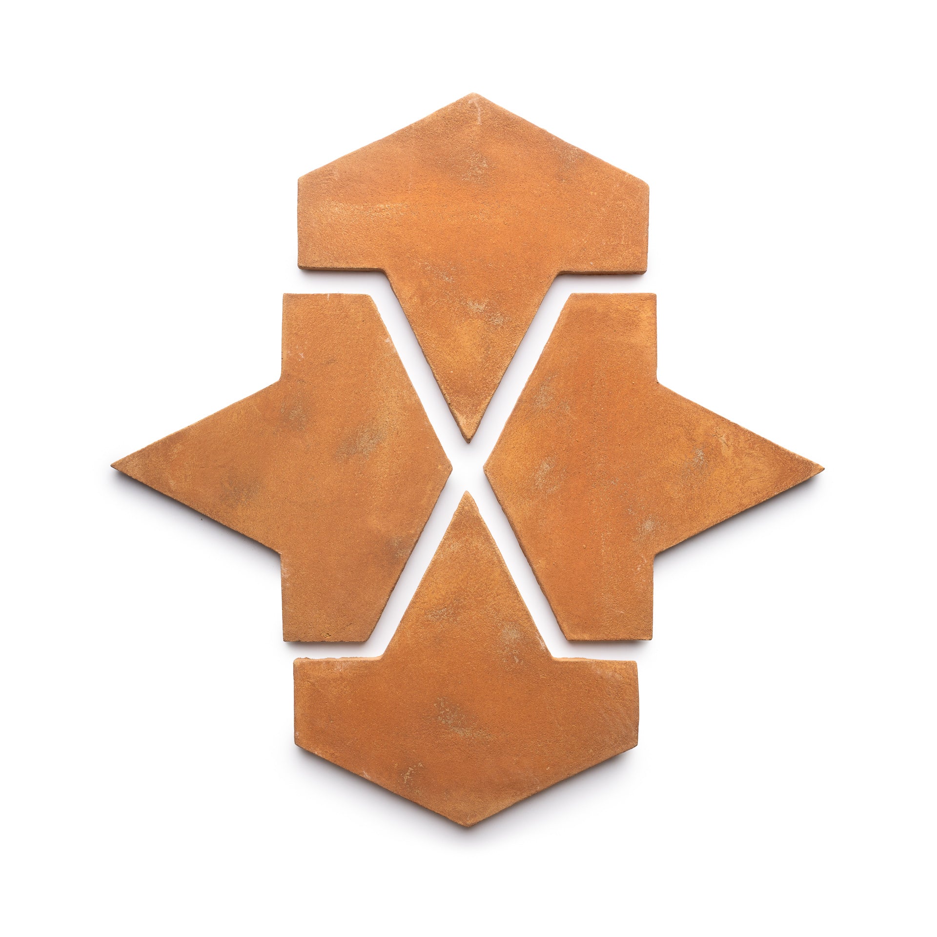 Four Big Alcazar + Fired Earth terracotta tiles by Zia Tile arranged on a white background, each arrowhead-shaped, form a geometric star-like pattern with an open center.