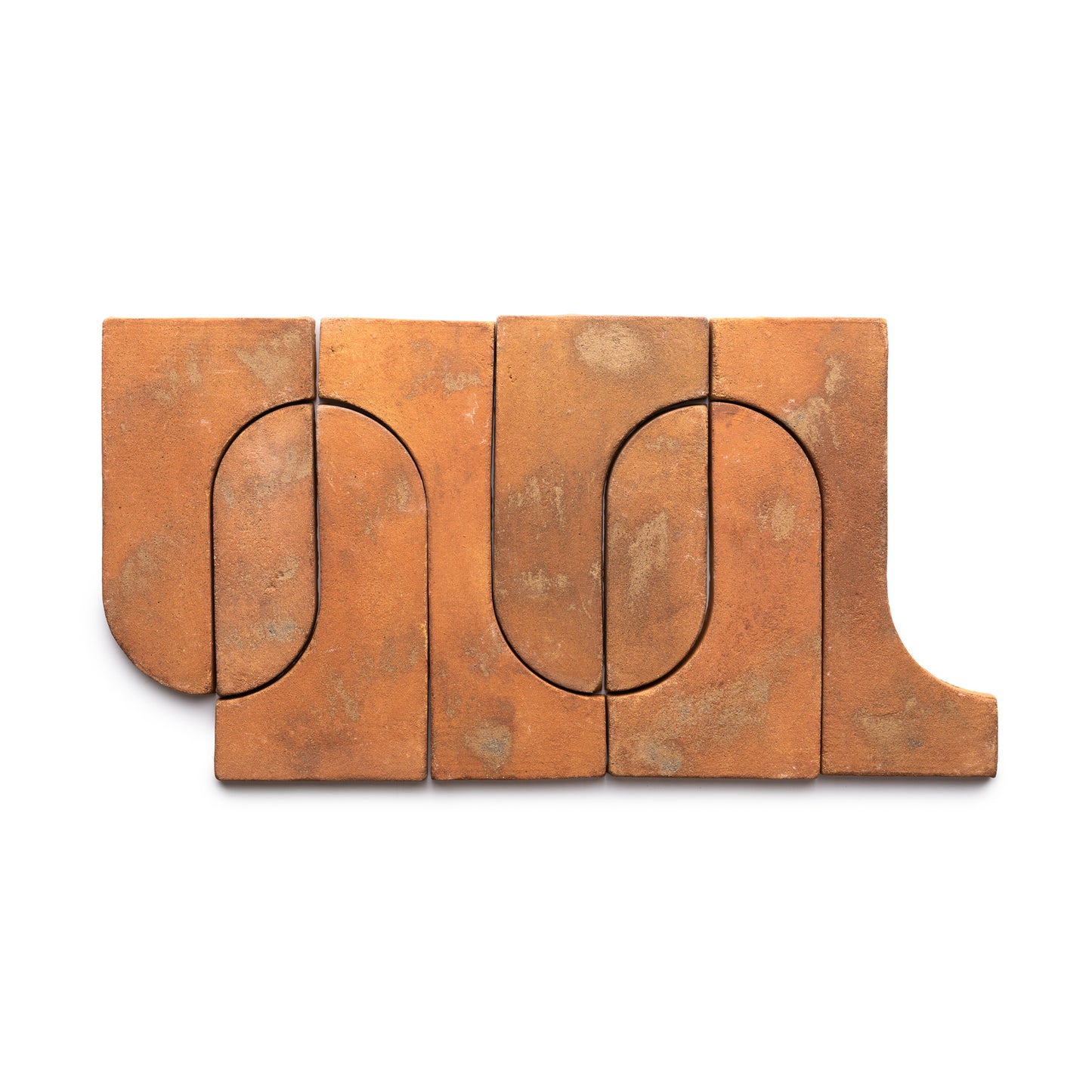 Durango + Fired Earth by Zia Tile: five interlocking terracotta tiles with curved and straight edges create abstract, continuous lines in a rectangular pattern on a white background.