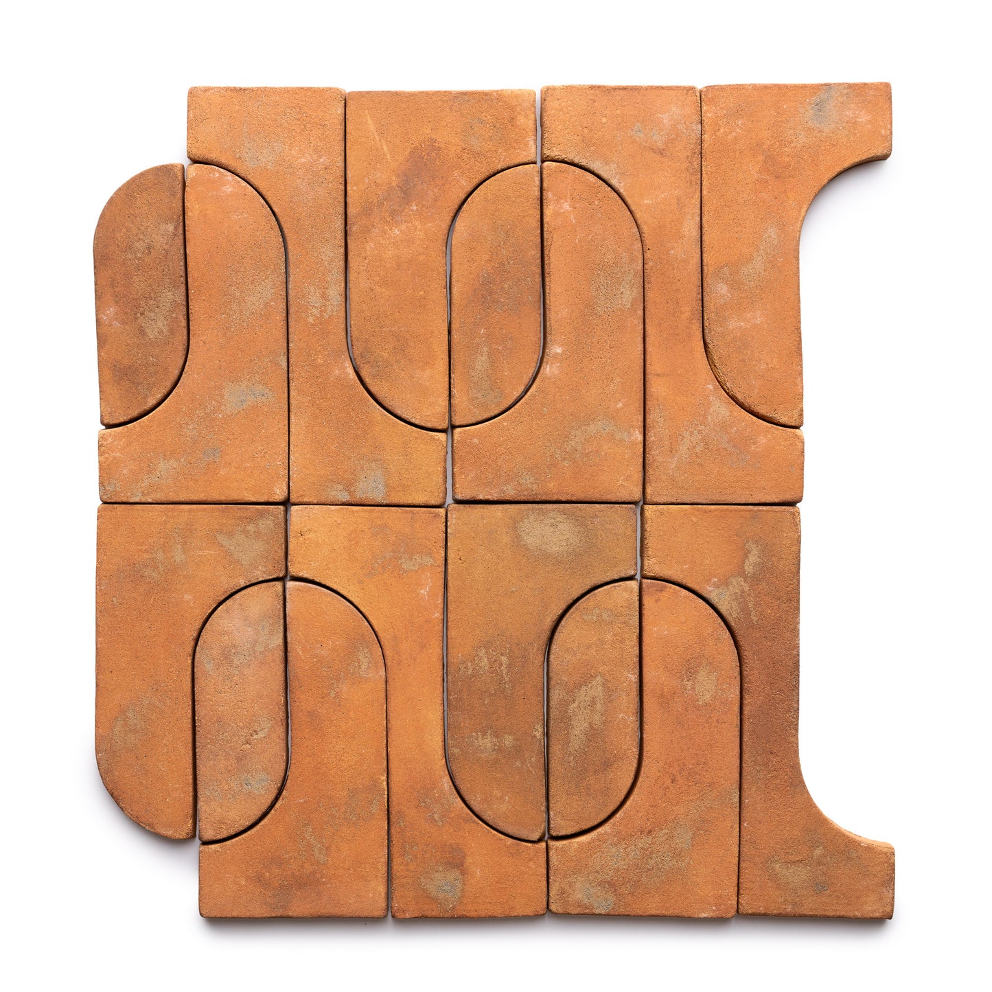 Durango + Fired Earth by Zia Tile features nine terracotta tiles with curved and straight edges that fit together like a puzzle, forming an abstract geometric pattern with a rustic, earthy texture.