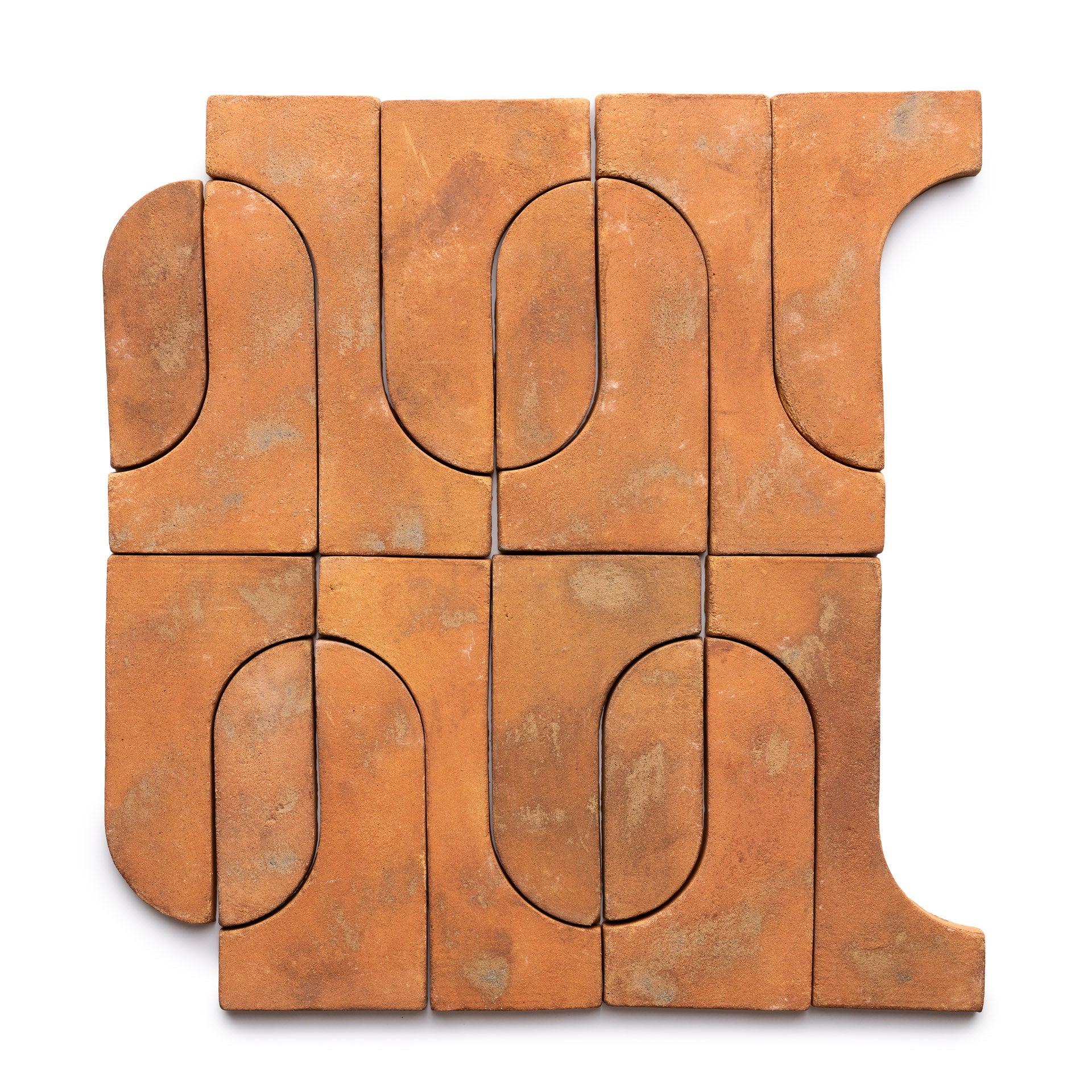 Durango + Fired Earth by Zia Tile features nine terracotta tiles with curved and straight edges that fit together like a puzzle, forming an abstract geometric pattern with a rustic, earthy texture.