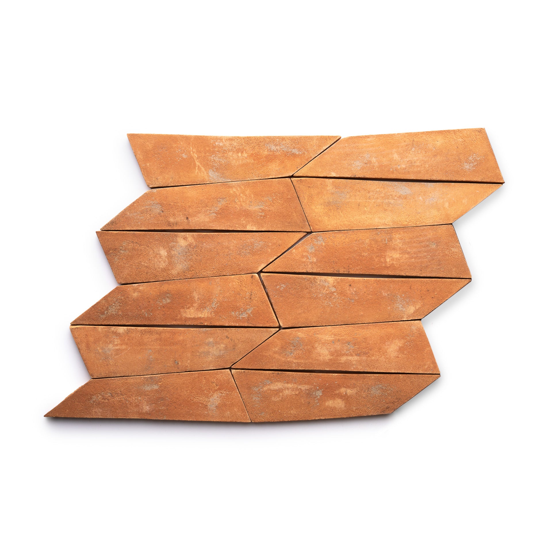 Eight Tornillo + Fired Earth tiles by Zia Tile, featuring an irregular elongated diamond shape and a weathered, rustic finish, are arranged in a staggered, interlocking pattern on a white background.