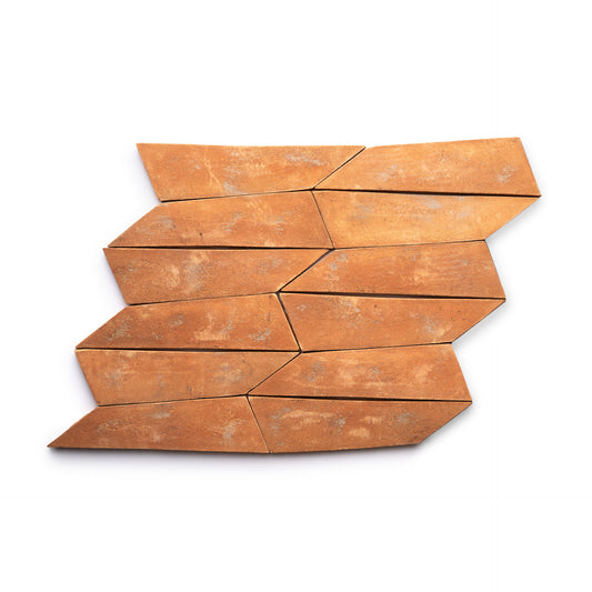 Eight Tornillo + Fired Earth tiles by Zia Tile, featuring an irregular elongated diamond shape and a weathered, rustic finish, are arranged in a staggered, interlocking pattern on a white background.