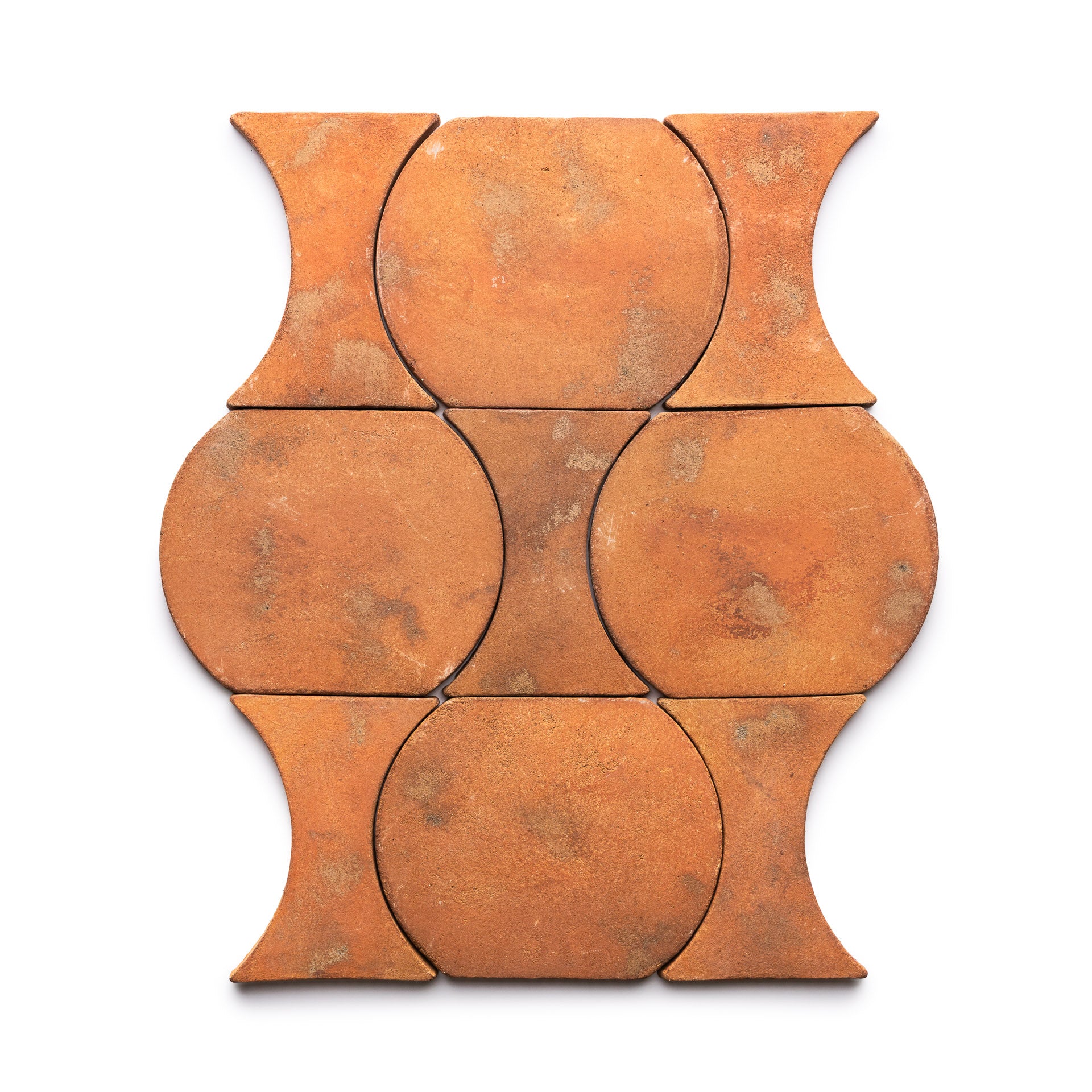 Six Oaxaca + Fired Earth terracotta tiles by Zia Tile arranged in a grid. Each features a circular center with outward curves on opposite sides, creating an interlocking pattern against a white background.