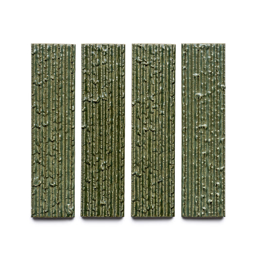 Four rectangular, vertically aligned green tiles from Zia Tile's Frogtown + Furrowed collection, featuring a textured, bark-like surface pattern and evenly spaced on a white background.