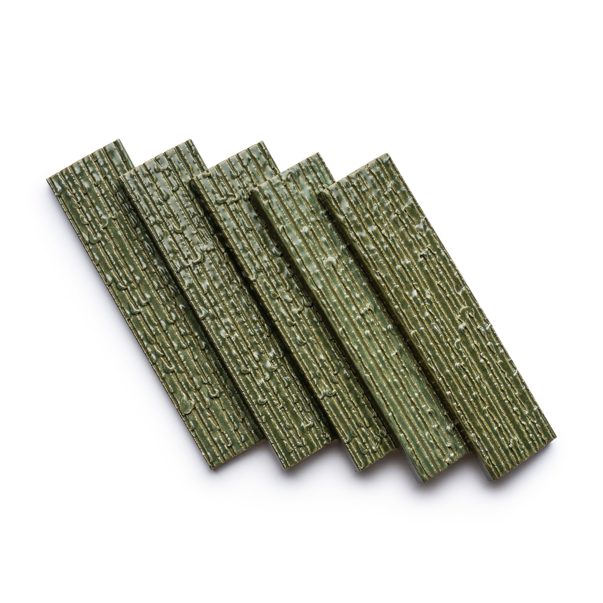 Five Frogtown + Furrowed green wafer tiles by Zia Tile, featuring a textured surface, are arranged in a fan shape on a white background.